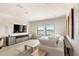 Relax in this bright living room offering serene lake views and featuring stylish decor at 15633 Panther Lake Dr, Winter Garden, FL 34787