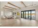 Bright living room with wood beam ceiling accents, folding doors to patio and serene water view at 15633 Panther Lake Dr, Winter Garden, FL 34787