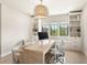 Bright office space featuring a travertine desk, custom shelves, and stylish decor at 15633 Panther Lake Dr, Winter Garden, FL 34787