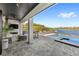 Covered outdoor living space with fireplace, seating, and pool views at 15633 Panther Lake Dr, Winter Garden, FL 34787
