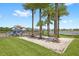 Community playground nestled beneath palm trees and featuring hammocks, with a water view at 15633 Panther Lake Dr, Winter Garden, FL 34787