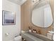 Stylish powder room with a unique sink, wood accent wall, and modern fixtures at 15633 Panther Lake Dr, Winter Garden, FL 34787