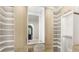 Spacious walk-in closet with custom shelving, vanity, and ample storage at 15633 Panther Lake Dr, Winter Garden, FL 34787