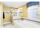 Luxurious bathroom features a soaking tub with elegant fixtures and a glass-enclosed shower at 1673 Moon Valley Dr, Davenport, FL 33896