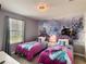 Charming ' bedroom with twin beds, a colorful mural, and a cozy ambiance at 1673 Moon Valley Dr, Davenport, FL 33896