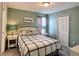 Cozy bedroom with a double bed, 'Choose Happy' wall art, and soft, neutral decor at 1673 Moon Valley Dr, Davenport, FL 33896