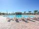 Resort-style pool area with lounge chairs and a shaded bar, perfect for relaxation and socializing at 1673 Moon Valley Dr, Davenport, FL 33896