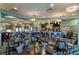 Elegant dining area with neatly arranged tables, comfortable seating, and a stylish bar area at 1673 Moon Valley Dr, Davenport, FL 33896