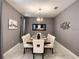 Elegant dining room with a large table, seating for ten, and stylish lighting fixture at 1673 Moon Valley Dr, Davenport, FL 33896