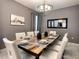 Elegant dining room with a large table, seating for ten, and stylish lighting fixture at 1673 Moon Valley Dr, Davenport, FL 33896