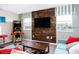 Fun game room with mounted TV, multi-arcade game and bright red bar stools at 1673 Moon Valley Dr, Davenport, FL 33896