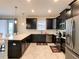 Modern kitchen with granite countertops, stainless steel appliances, and an island with seating at 1673 Moon Valley Dr, Davenport, FL 33896
