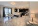 Open-concept kitchen and dining area with modern furnishings and a seamless flow for entertaining at 1673 Moon Valley Dr, Davenport, FL 33896