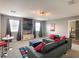 Spacious second-floor living room with comfortable seating, a large TV, and modern decor at 1673 Moon Valley Dr, Davenport, FL 33896
