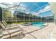 Enjoy this screened-in outdoor pool with a hot tub and ample seating for relaxation at 1673 Moon Valley Dr, Davenport, FL 33896