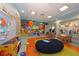 Vibrant ' play area with colorful mural, soft play area, and tables for activities at 1673 Moon Valley Dr, Davenport, FL 33896