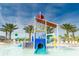 Fun water park area featuring slides, water features, and palm trees for a tropical feel at 1673 Moon Valley Dr, Davenport, FL 33896