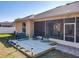 Backyard featuring a wooden deck, outdoor seating, a screened patio and lush landscaping at 1913 Lazy Oaks Loop, St Cloud, FL 34771