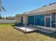 Enjoy a backyard space, deck for lounging and exterior access from the screened in patio at 1913 Lazy Oaks Loop, St Cloud, FL 34771