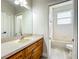 Traditional bathroom with a single sink vanity, a large mirror, and a separate toilet and tub/shower room at 1913 Lazy Oaks Loop, St Cloud, FL 34771