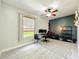 Brightly lit room featuring a wooden ceiling fan, office setup, light gray walls, and natural lighting at 1913 Lazy Oaks Loop, St Cloud, FL 34771