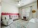 Bedroom with pastel color accents, featuring a glider, crib, patterned rug, and plenty of natural light at 1913 Lazy Oaks Loop, St Cloud, FL 34771