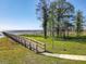 Community boardwalk leading to a scenic lake view, perfect for leisurely strolls and enjoying nature at 1913 Lazy Oaks Loop, St Cloud, FL 34771