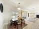 Dining area showcasing a wooden table, seating for four, and a view to the outdoor patio at 1913 Lazy Oaks Loop, St Cloud, FL 34771