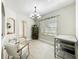 Dining room featuring light wood-look tile floors and a contemporary chandelier at 1913 Lazy Oaks Loop, St Cloud, FL 34771
