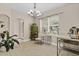 Inviting dining room with neutral paint, a chandelier, a garden view, and modern floors at 1913 Lazy Oaks Loop, St Cloud, FL 34771