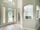 Bright entryway with decorative glass doors and an arched window allowing natural light at 1913 Lazy Oaks Loop, St Cloud, FL 34771