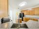 Bright kitchen featuring wood cabinets, granite countertops and stainless steel appliances at 1913 Lazy Oaks Loop, St Cloud, FL 34771