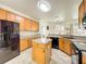 Well lit kitchen equipped with stainless steel appliances, a center island, and wood cabinets at 1913 Lazy Oaks Loop, St Cloud, FL 34771
