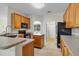 Kitchen with wooden cabinets, granite counters, an island and stainless steel appliances at 1913 Lazy Oaks Loop, St Cloud, FL 34771