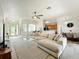 Open-concept living space with wood-look tile flooring and plentiful natural light at 1913 Lazy Oaks Loop, St Cloud, FL 34771