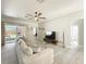 Comfortable living room with wood-look tile flooring and a cozy sectional couch at 1913 Lazy Oaks Loop, St Cloud, FL 34771