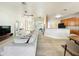 Spacious living room with a light gray sectional sofa and an open floorplan to the kitchen at 1913 Lazy Oaks Loop, St Cloud, FL 34771