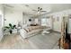 Open-concept living room with wood-look tile and a plush sectional couch at 1913 Lazy Oaks Loop, St Cloud, FL 34771