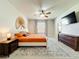 Main bedroom featuring a ceiling fan, decorative wall art, and matching night stands at 1913 Lazy Oaks Loop, St Cloud, FL 34771