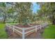 Community playground with slides and swings is surrounded by a white fence and mature trees at 1913 Lazy Oaks Loop, St Cloud, FL 34771