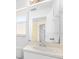 Bathroom featuring a single sink vanity, large mirror, and neutral colors at 1960 Evard Ave, Deltona, FL 32725