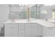 Well-lit bathroom features a double vanity, modern fixtures, and a glass enclosed shower for a clean aesthetic at 1960 Evard Ave, Deltona, FL 32725