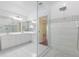 Modern bathroom with double vanity, tiled floors, frameless glass shower showcasing contemporary design at 1960 Evard Ave, Deltona, FL 32725