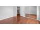 Bedroom featuring wood floors, mirrored sliding door closet and an attached bathroom at 1960 Evard Ave, Deltona, FL 32725