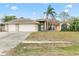 Charming single-story home with a two-car garage and a well-manicured front yard at 1960 Evard Ave, Deltona, FL 32725