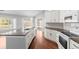 Bright kitchen with hardwood floors, white cabinetry, an island and modern appliances at 1960 Evard Ave, Deltona, FL 32725