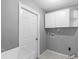Functional laundry room with tiled floors and utility sink at 1960 Evard Ave, Deltona, FL 32725