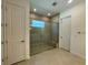 Bathroom showing large tiled shower stall with glass door and tile floors at 2010 Divot Dr, Daytona Beach, FL 32124