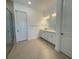 Bathroom with double sink vanity, large mirror, and tiled walk-in shower at 2010 Divot Dr, Daytona Beach, FL 32124