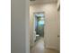 Hallway view of a bathroom with walk-in shower, tiled walls, and a single sink vanity at 2010 Divot Dr, Daytona Beach, FL 32124